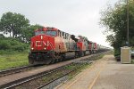 Westbound mixed freight races through the station